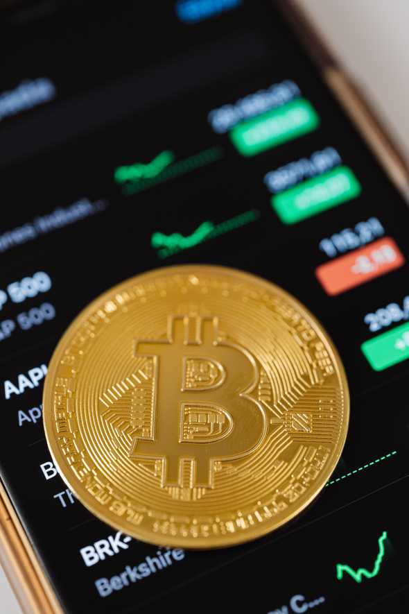 Trade anywhere! person holding a smartphone with a cryptocurrency app open
